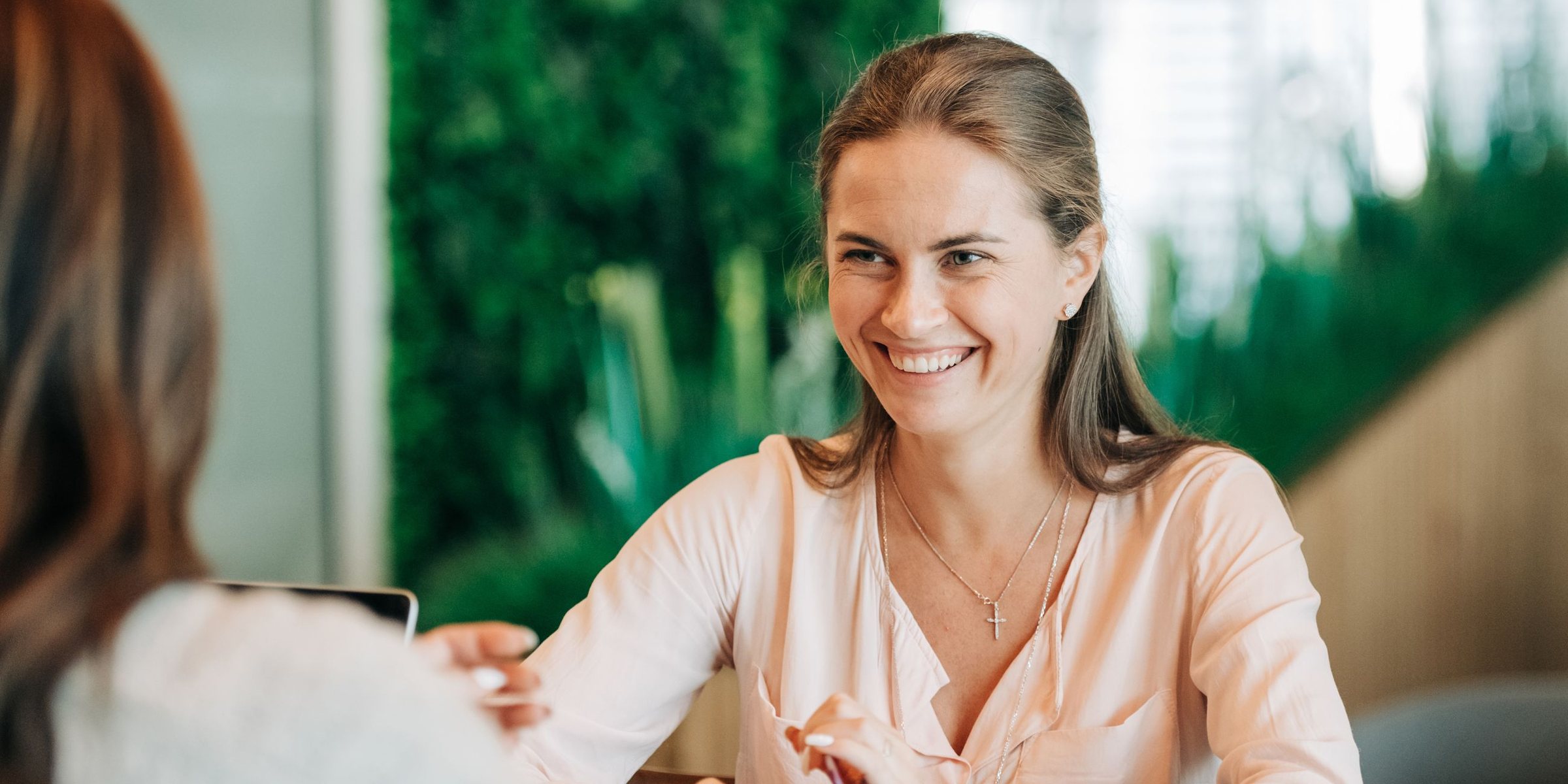 Consultant in a friendly conversation with a client across a table